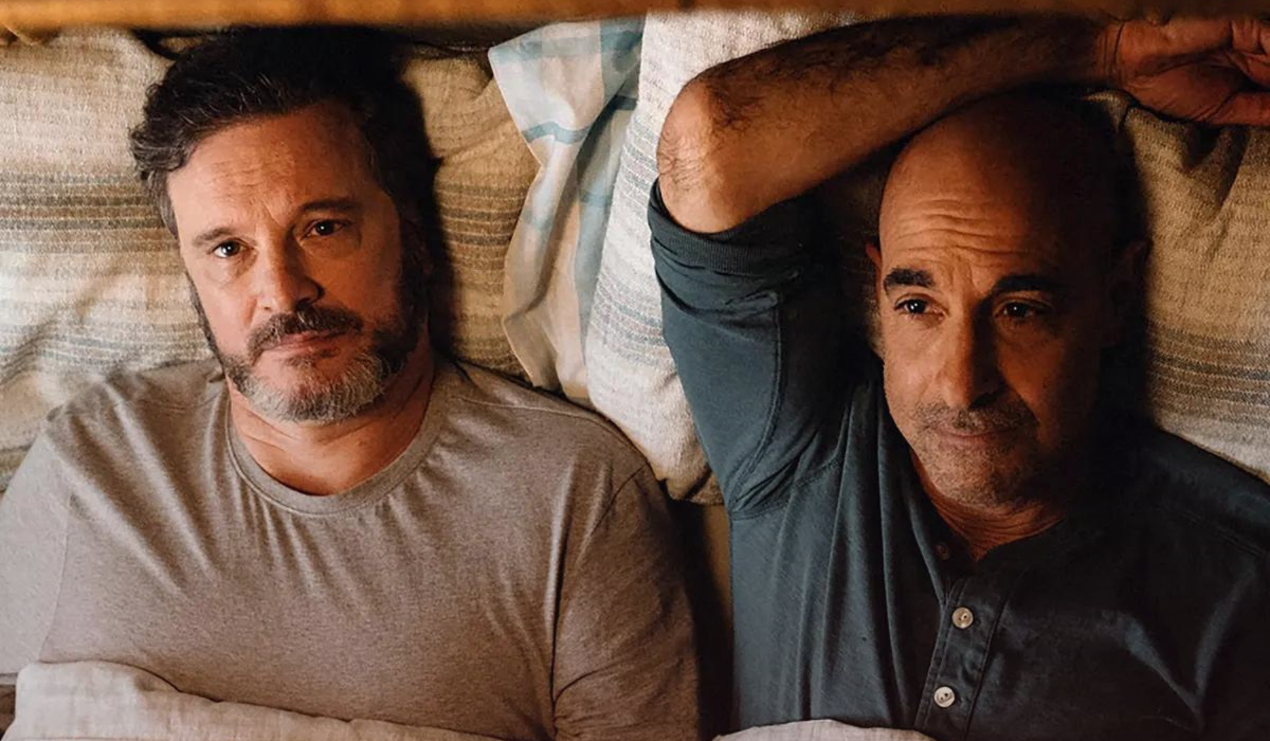 Colin Firth and Stanley Tucci in Supernova laying in a bed together