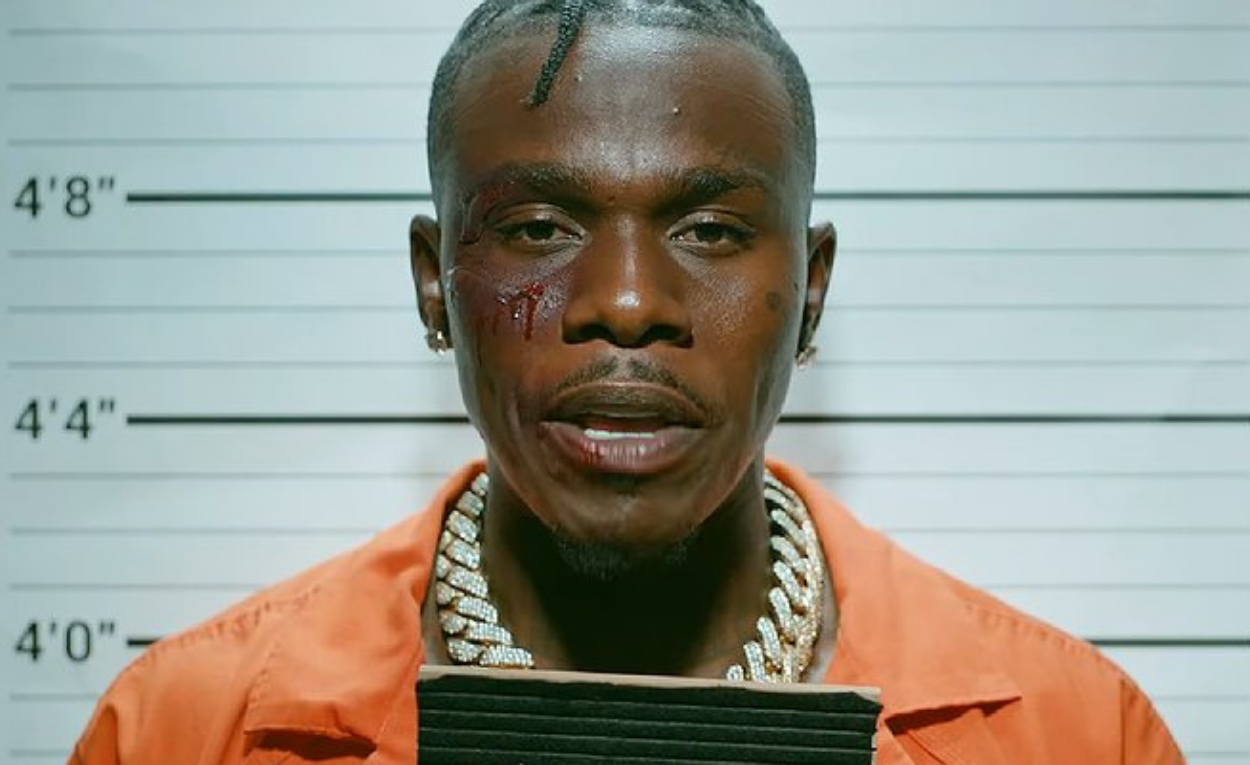 DaBaby in orange jumpsuit, pictured from music video